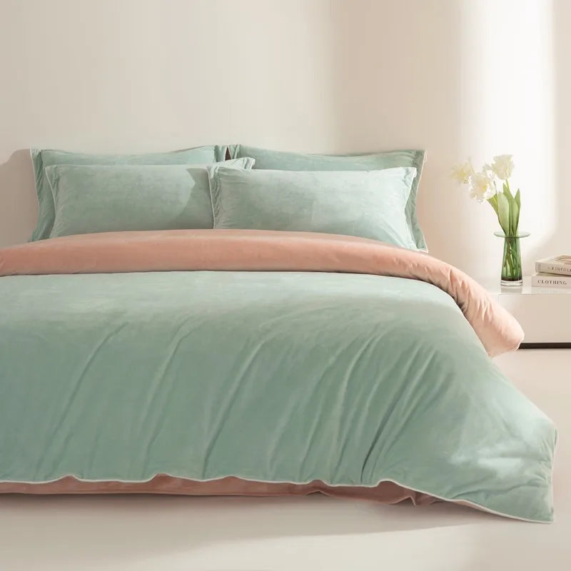 Bed with light green bedding and peach trim in a bedroom setting.