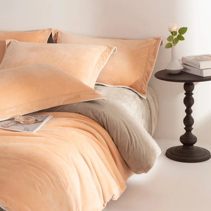 Bed with peach-colored bedding and pillows in a bedroom setting.