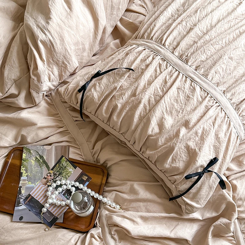 Beige comforter and pillow on a bed 