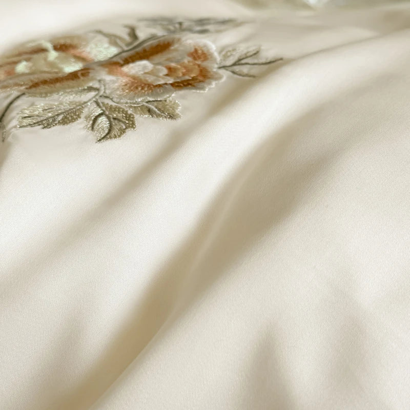 Close-up 600TC Chiffon Ruffle Princess  Silky fabric with floral embroidery on a beige background
