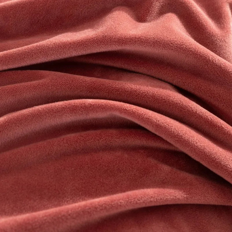 Close-up of a textured pinkish-red duvet cover with folds