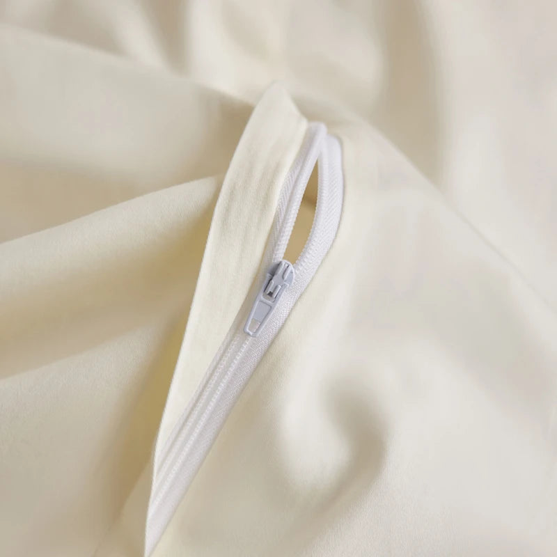 Close-up of a zipper on a beige fabric surface