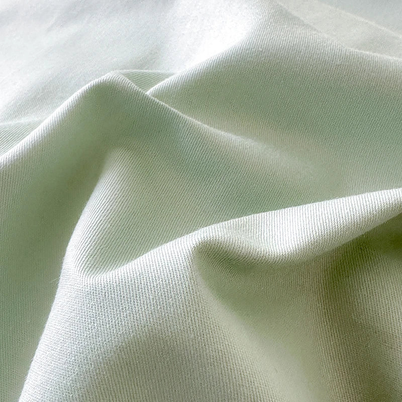 Close-up of light green fabric with visible texture