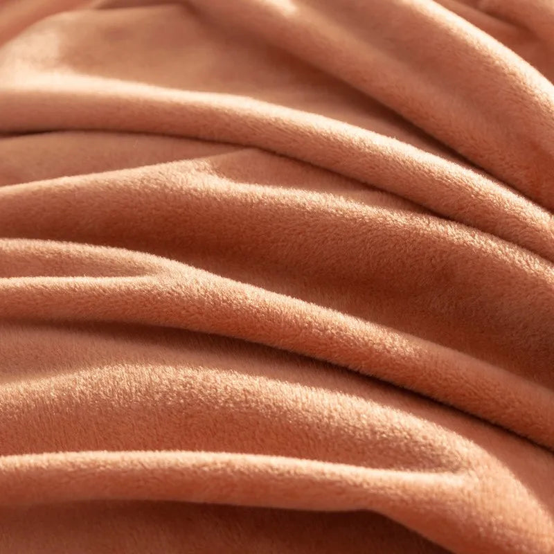 Close-up of soft, peach-colored bedsheet fabric