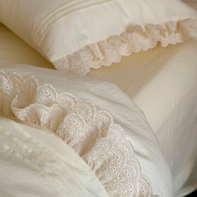 Close-up of white lace-trimmed pillow case ruffled bedding set