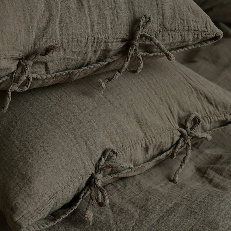 Close up of 600TC Cotton Twill Wrinkled Yarn Bedding Pillowcases with bow tie at The Happy Ladies