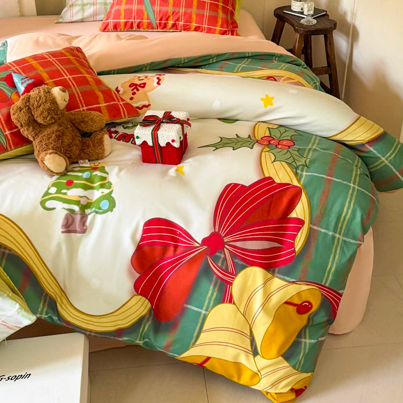 Decorative bedspread with Christmas-themed design featuring red bows and yellow bells on a bed.