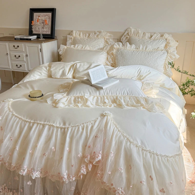 Delicate white ruffled princess king size bedding set on a bed