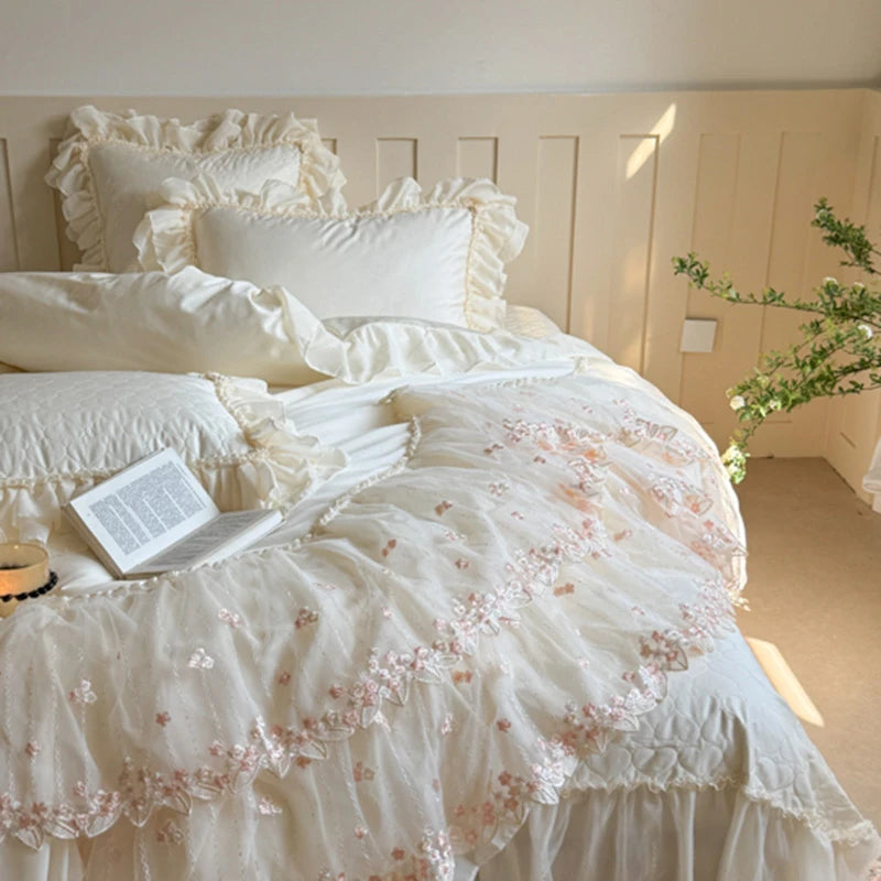 Egyptian cotton Delicate white bedding with floral embroidery on a bed in a softly lit room.