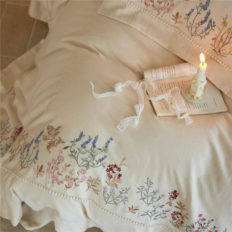 Embroidered bedding set with floral patterns includes pillow cases and duvet cover.