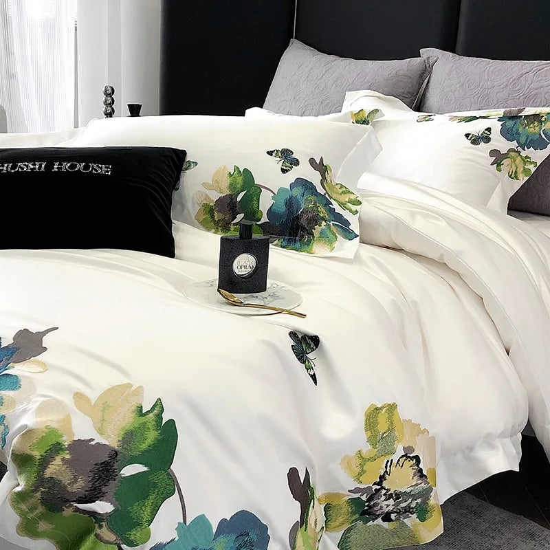 Floral-patterned bedding set on a bed with decorative pillows and a candle.