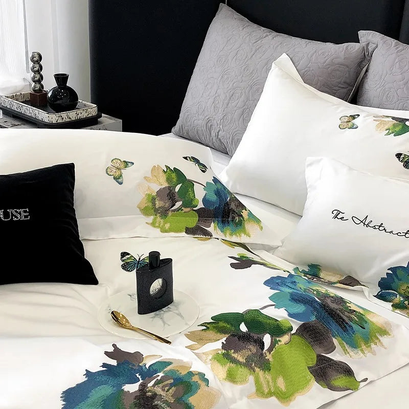 Floral-patterned bedding with decorative pillows and a black pillow on a bed.