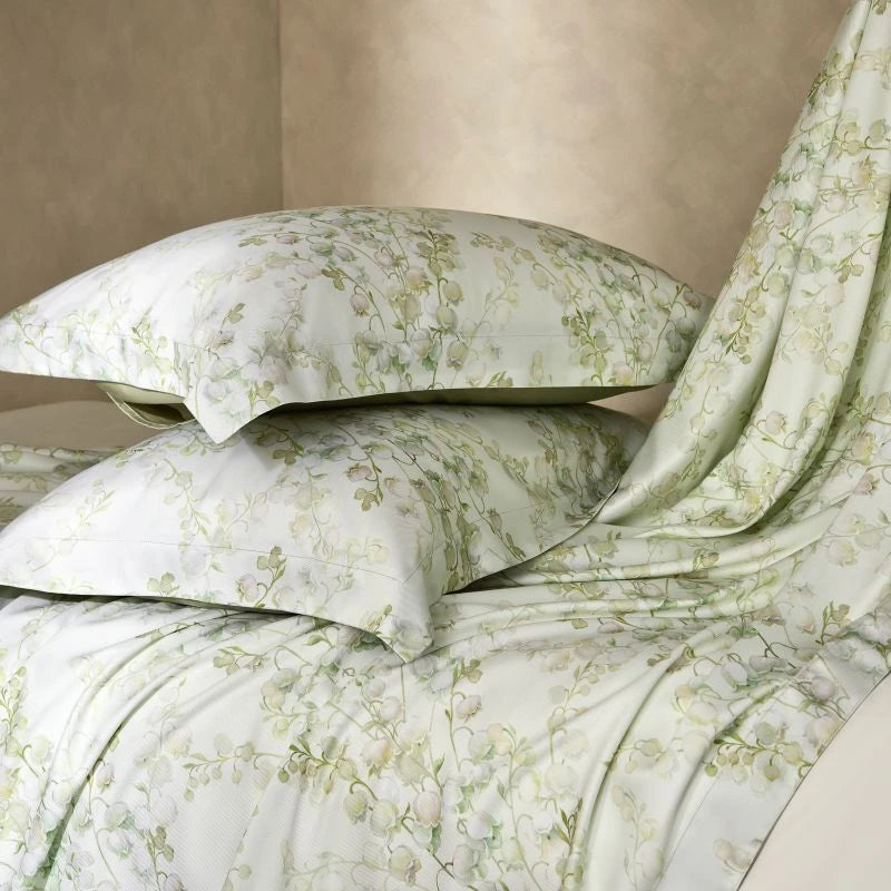 Floral patterned bedding set with pillows on a neutral background