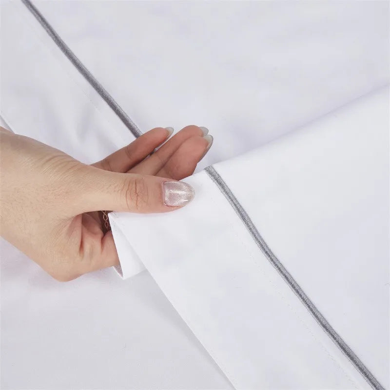 Hand holding a white sheet against a light gray background