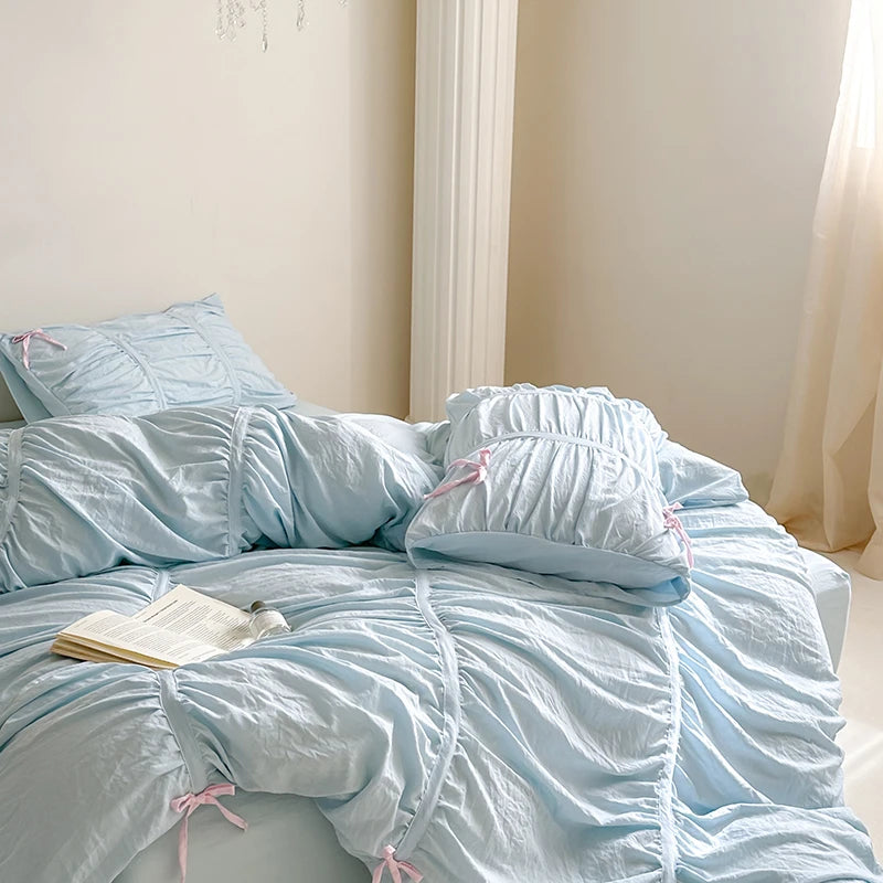 Light blue bedding set on a bed 