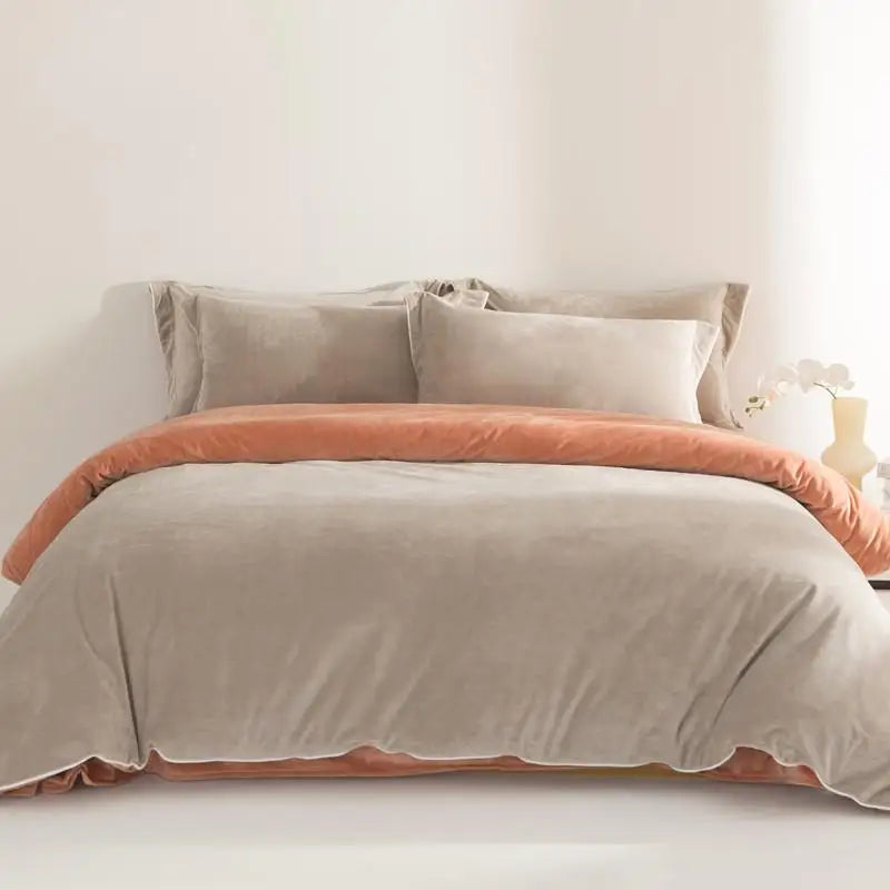 Neatly made bed with beige and pink bedding in a softly lit room.