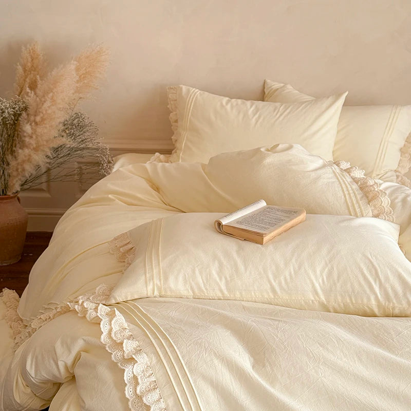 Neatly made bed with cream-colored ruffled bedding