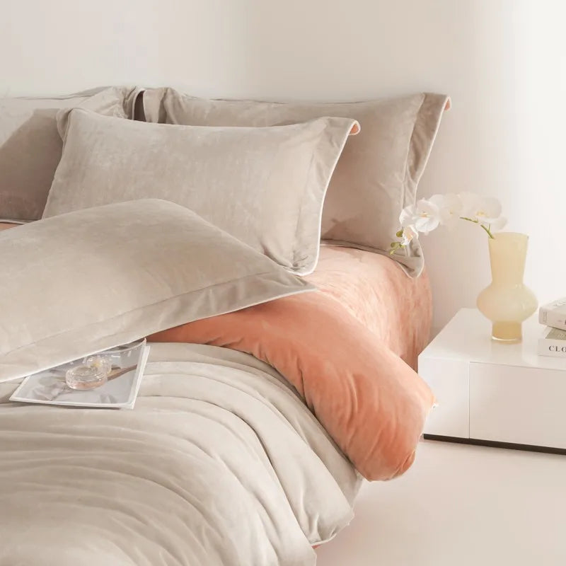Neatly made bed with light-colored bedding and pillows in a bedroom setting.