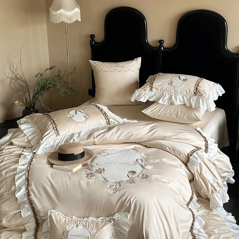 Neatly made beige bed with decorative pillows and bedding in a bedroom setting.