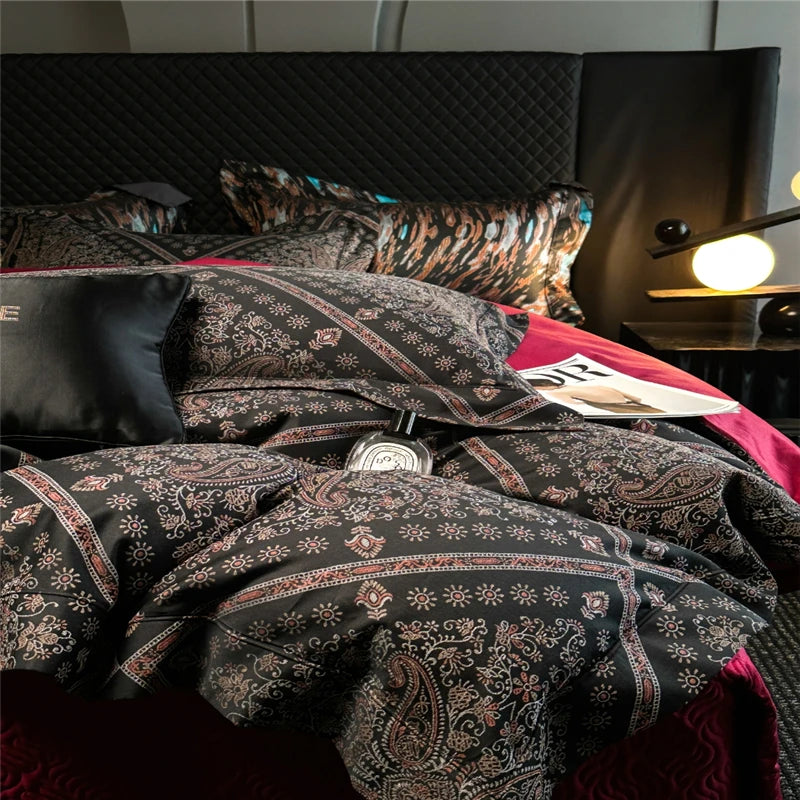 Patterned bedding on a bed with a lamp in the background