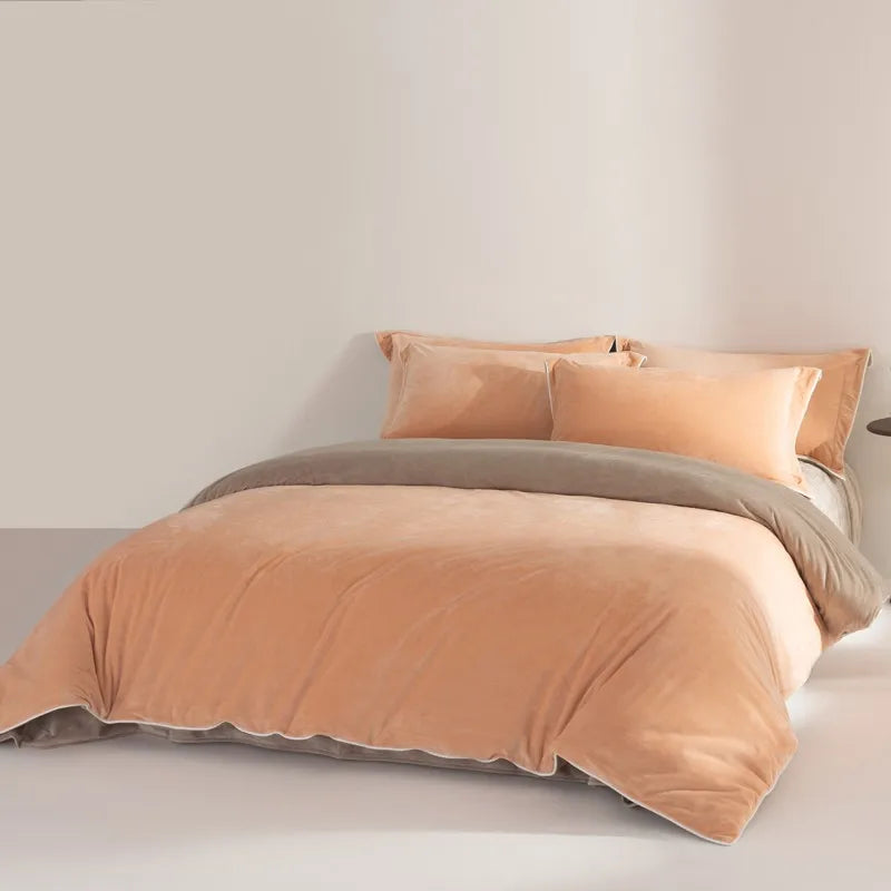 Peach and brown bedding set on a bed with a plain background