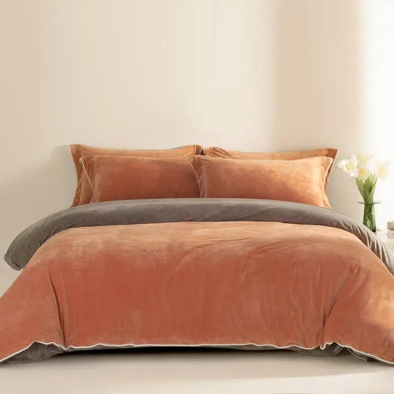 Rust and gray bedding set on a bed with a neutral background