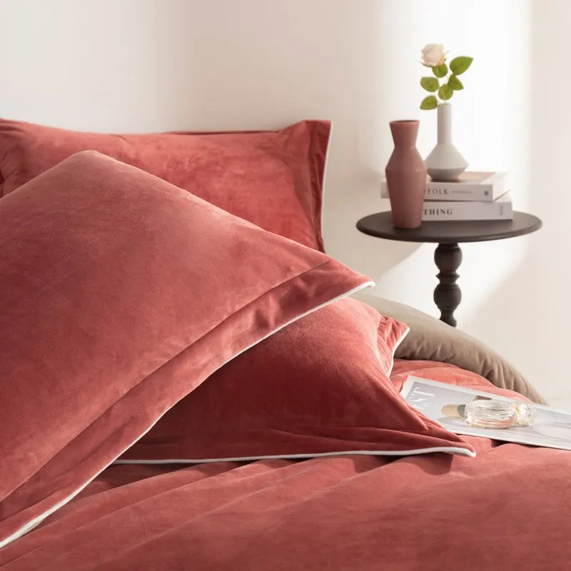 Rust velvet bedding set with a side table in the background