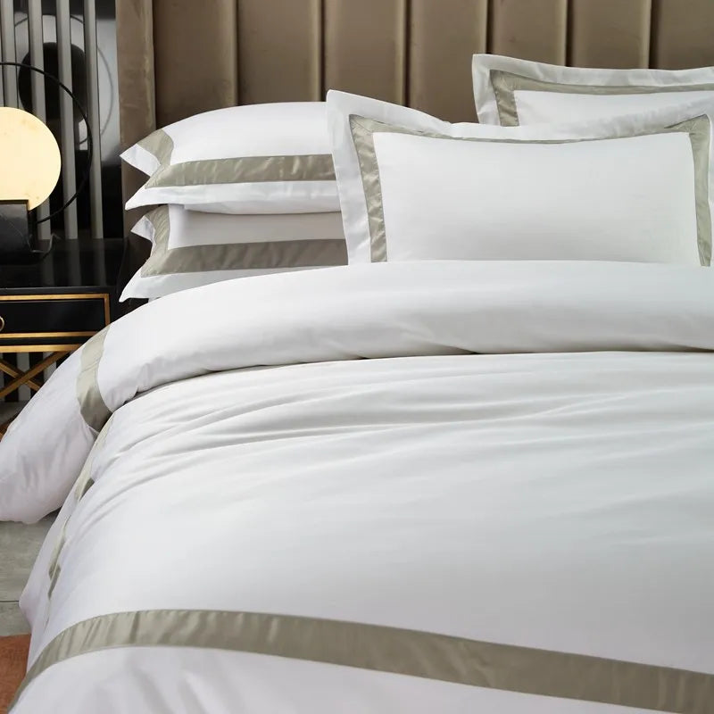 White bedding set with stripes on a bed in a bedroom setting.