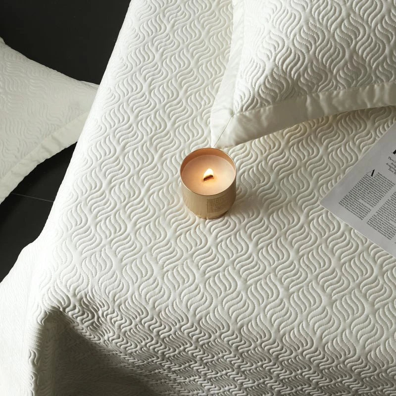 White textured bedspread close up image 