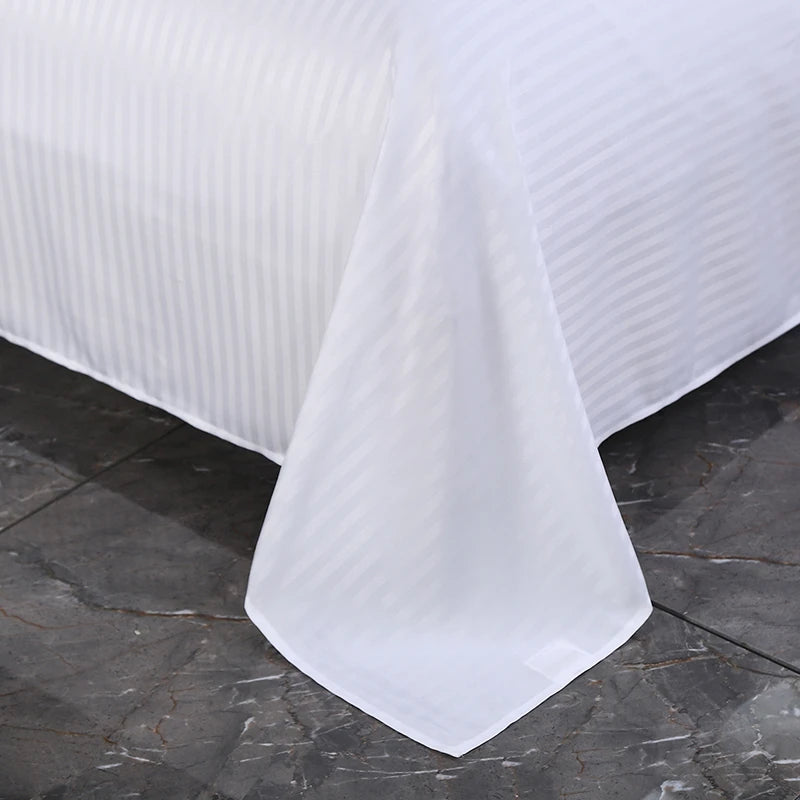 White textured flat bedding set on a dark stone surface